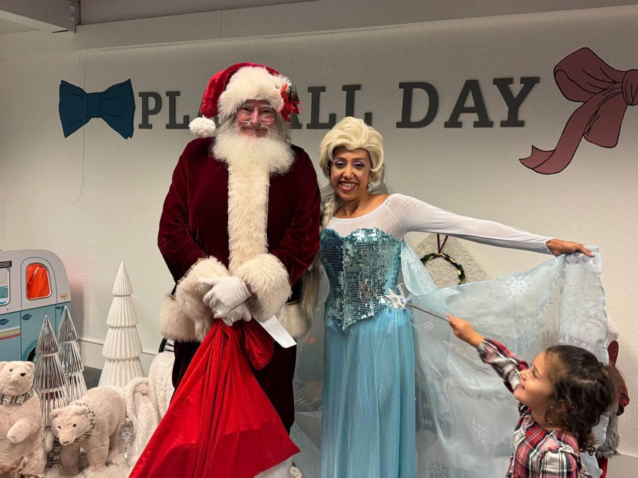 Elsa costumed character at a Christmas kids event with Santa