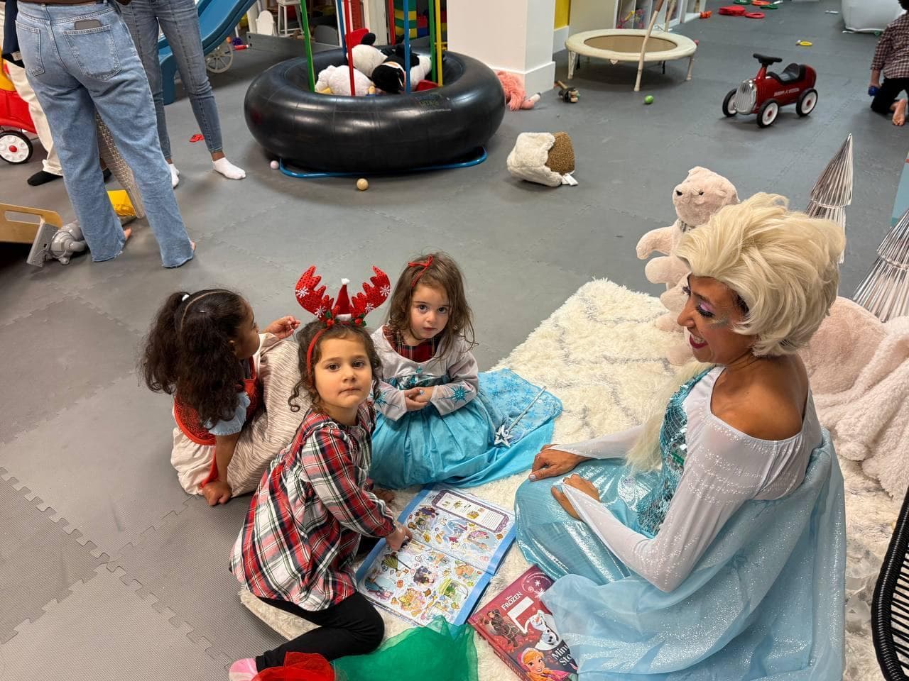 Elsa party entertainer playing with kids at a Frozen themed birthday party
