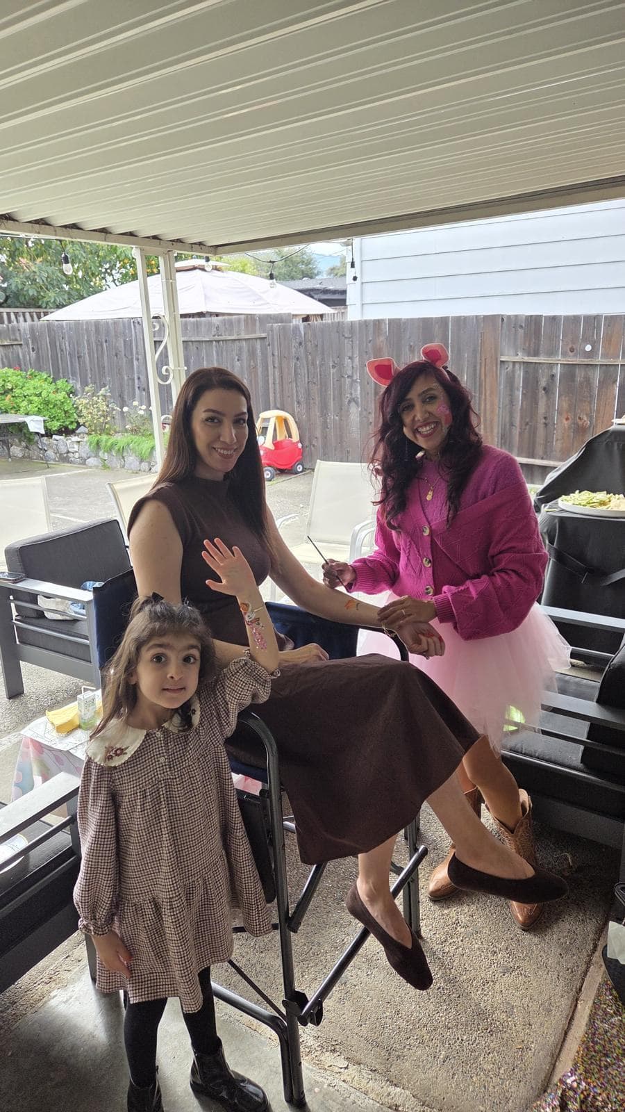 Glitter face painting for a girl at an outdoor birthday party