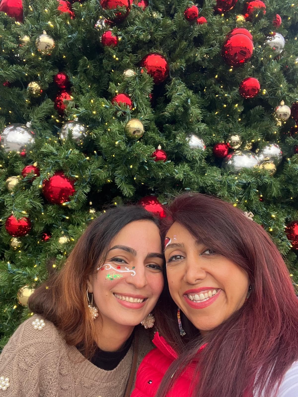 Rainbow holiday face painting for adults at a Christmas party