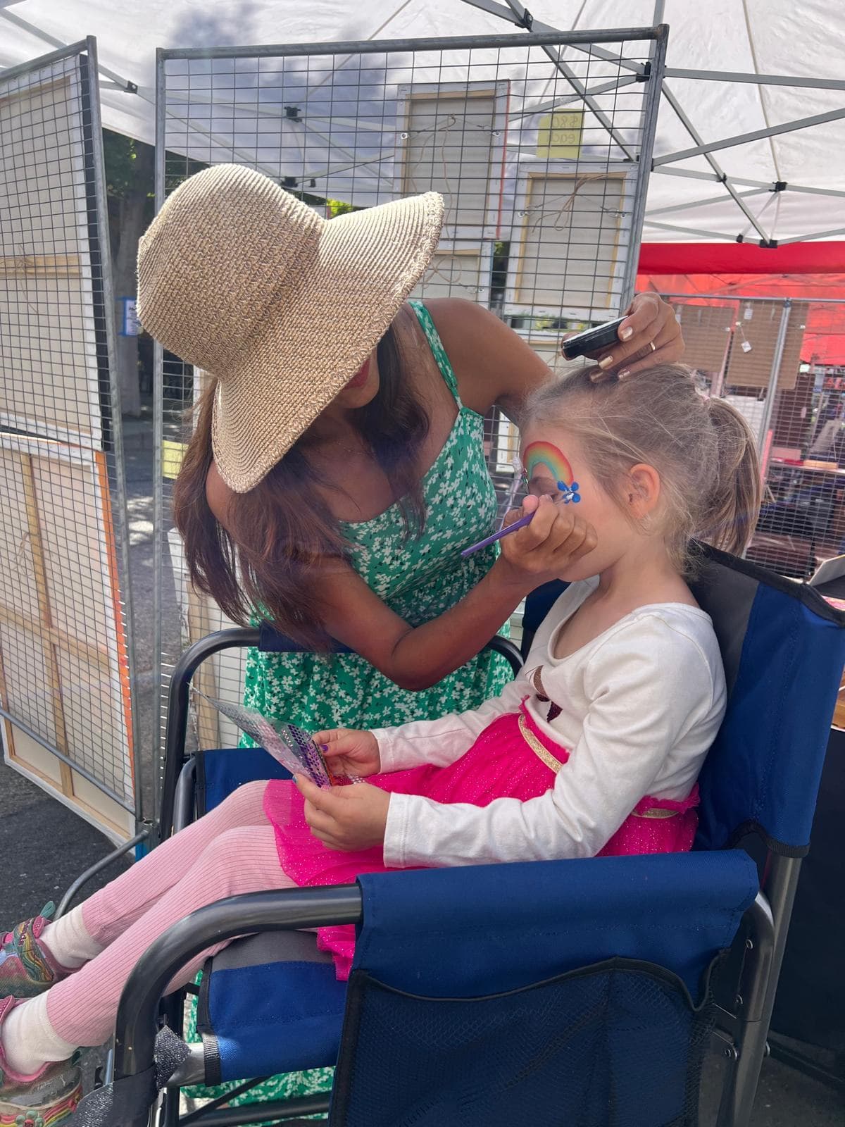 Kids face painting booth at a community festival in the Bay Area