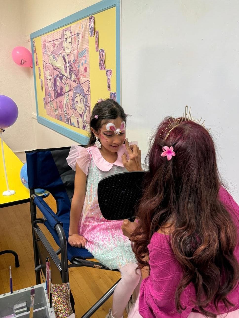 Princess face painting for a girl at an indoor birthday party