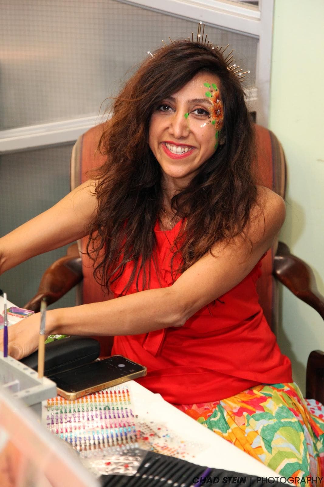 Professional face painter at work with a face paint palette